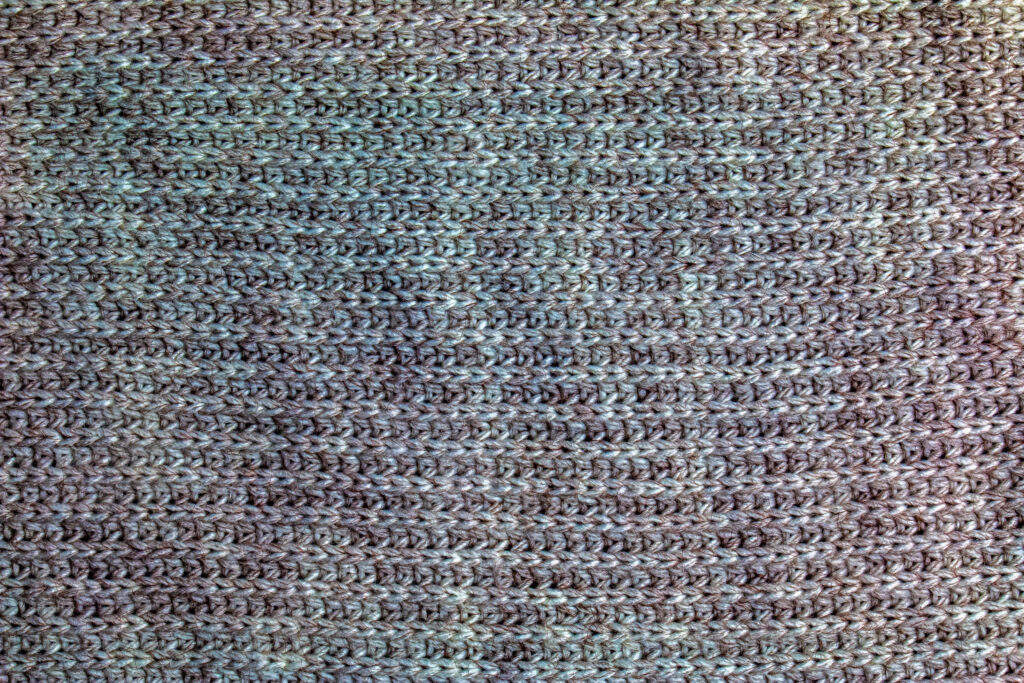 Cozy Knitted Wool Texture: Intricate Stitching Wallpaper Background