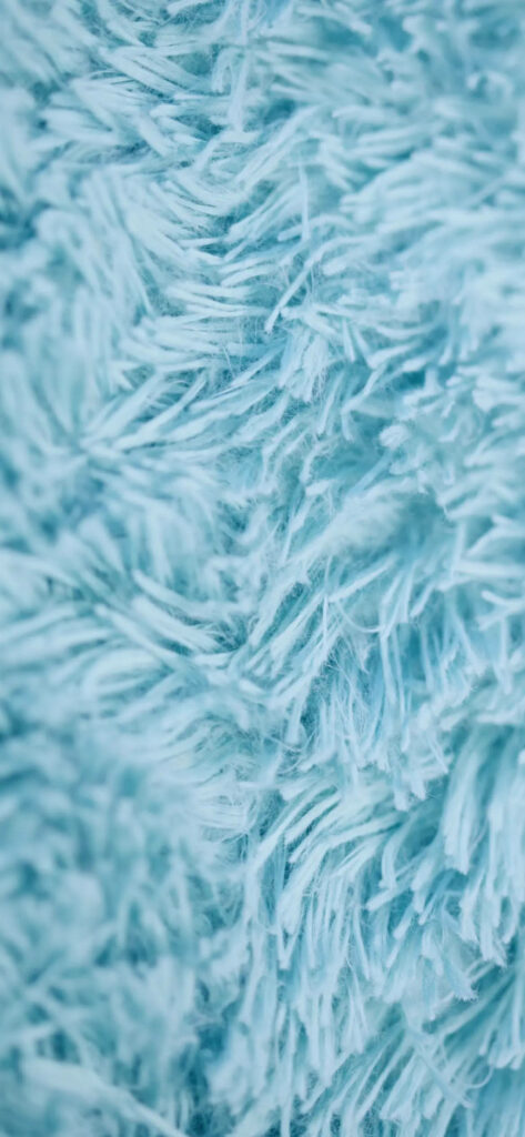 Soft Light Blue Fabric: Fluffy Cozy Wallpaper Background Close-Up