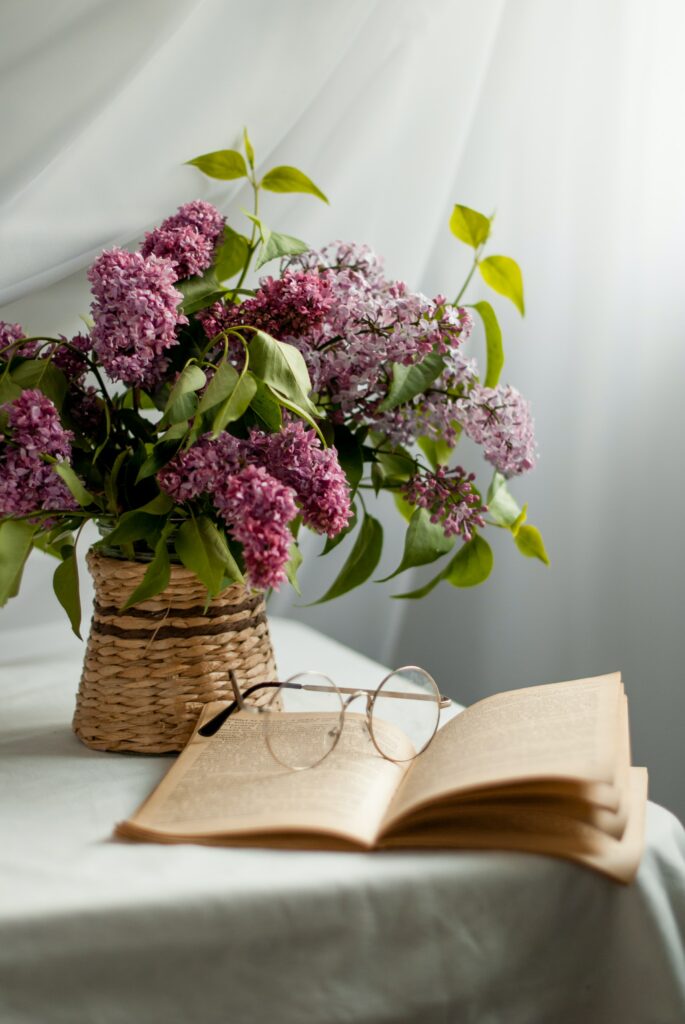 Serene Wallpaper: Wicker Vase & Lilac Flowers in Cozy Setting