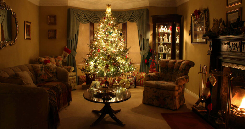 Cozy Living Room with Sparkling Christmas Tree and Warm Fireplace Wallpaper