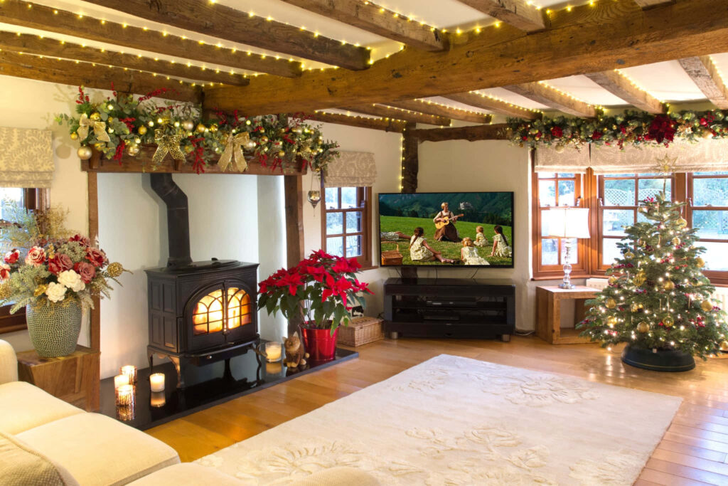 Cozy Winter Living Room with Wood Beams, Fireplace & Holiday Decor Wallpaper