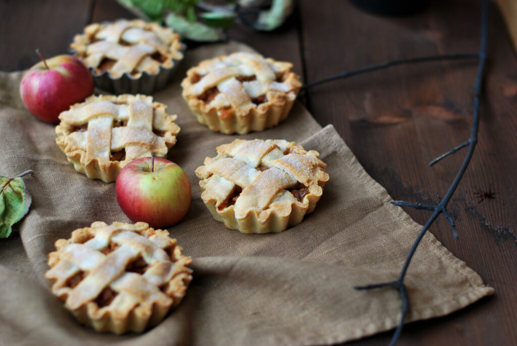 Cozy Wallpaper of Delicious Mini Apple Pies on Rustic Table