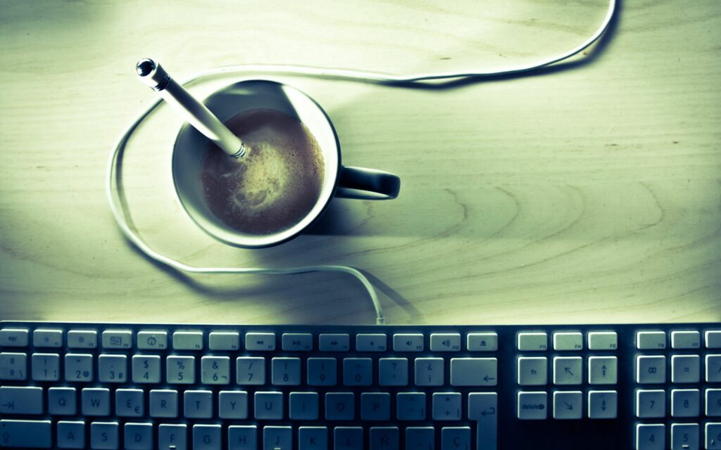 Minimalist Workspace Wallpaper: Cozy Desk Setup with Coffee & Keyboard