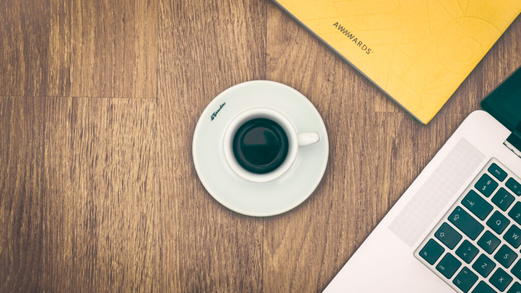 Cozy Minimalist Wallpaper: Coffee, Yellow Notebook & Laptop Scene