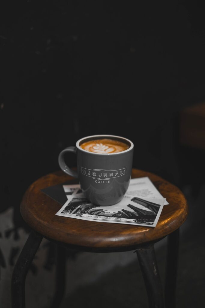 Cozy Coffee on Rustic Stool with Black & White Prints - Wallpaper