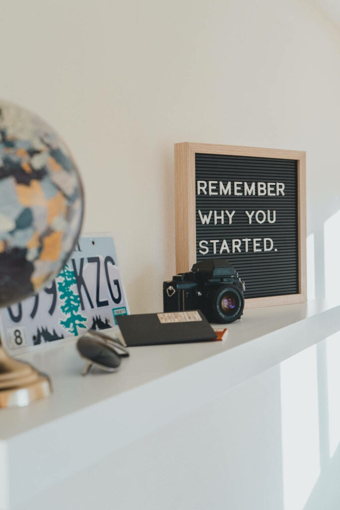 Cozy Minimalist Shelf with Motivational Quote & Decor Elements Wallpaper