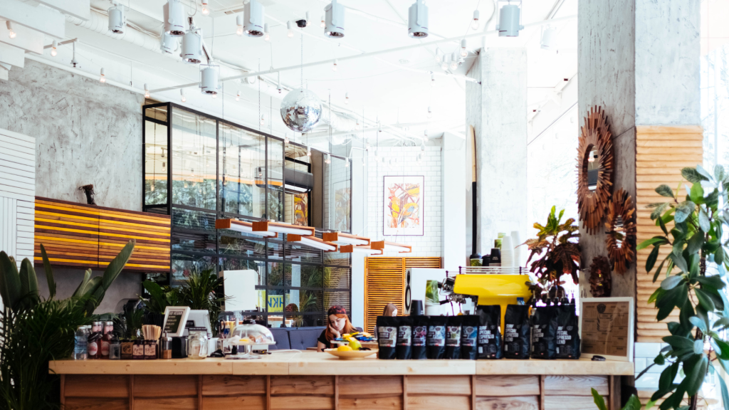 Cozy modern coffee shop interior with rustic wood counter green plants and disco ball decor wallpaper
