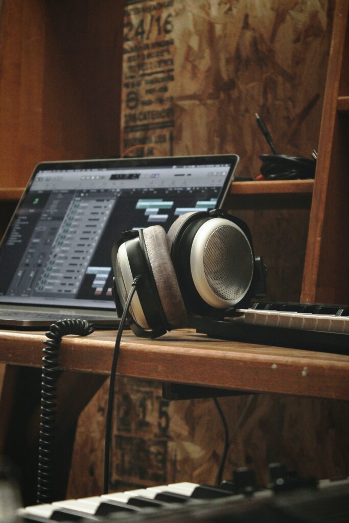 Cozy Music Production Setup Wallpaper: Headphones & Synthesizer
