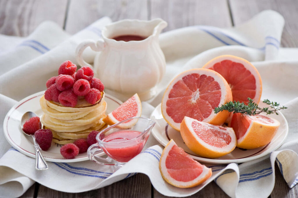 Cozy Wallpaper: Pancakes, Raspberries & Grapefruits on Wood