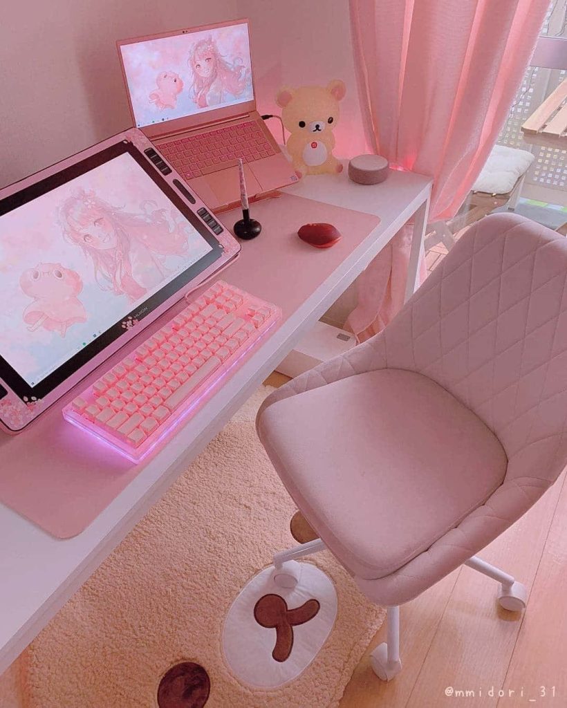 Cozy pink gaming setup with tufted chair Huion pen display Rilakkuma lamp and mat wallpaper