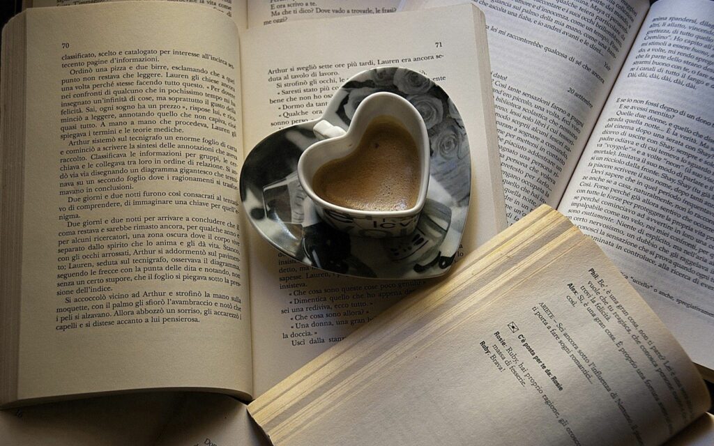 Cozy Reading Nook: Heart Mug & Open Book Wallpaper Background