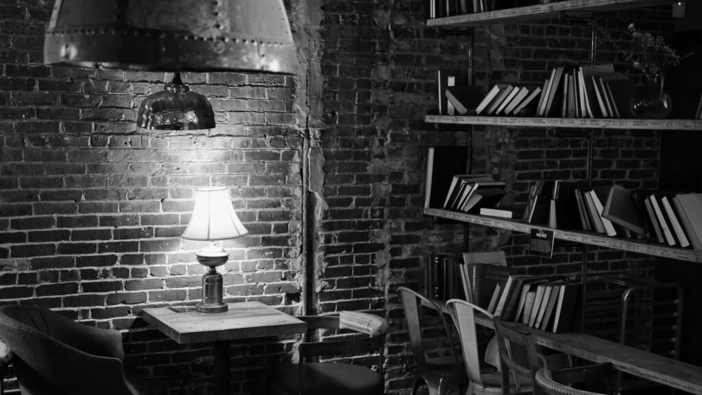 Cozy Reading Nook Wallpaper: Rustic Brick Wall & Warm Lighting