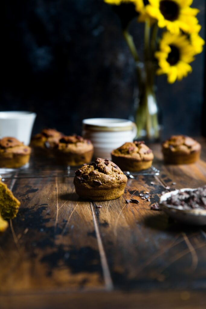 Cozy Rustic Chocolate Muffins with Sunflowers Wallpaper Background