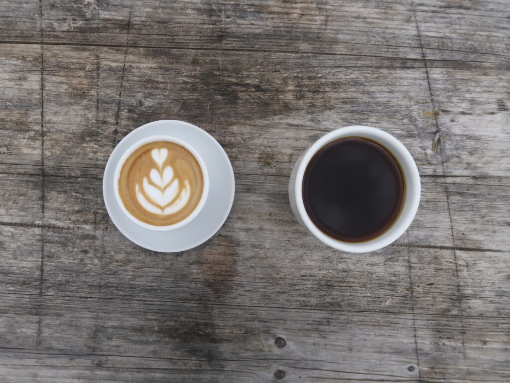 Rustic Wooden Table with Cappuccino & Black Coffee Wallpaper