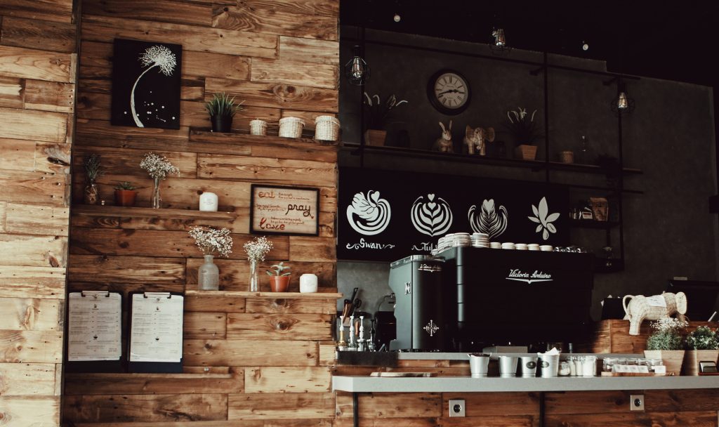 Cozy rustic coffee shop wallpaper with wooden panels espresso machine latte art decor plants