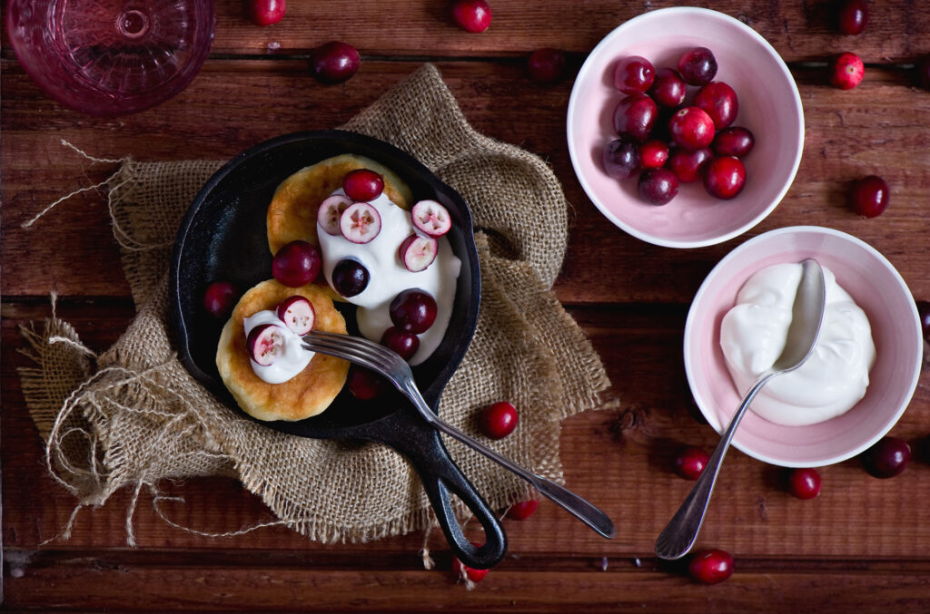 Cozy Rustic Pancake Setup: Sour Cream & Cranberries on Wood Wallpaper