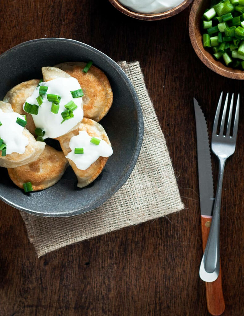 Rustic Golden Brown Pierogi Wallpaper with Spring Onions & Sour Cream