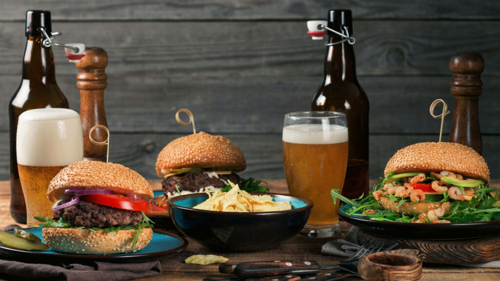 Rustic Beer & Burger Wallpaper: Cozy Wooden Table Dining Scene