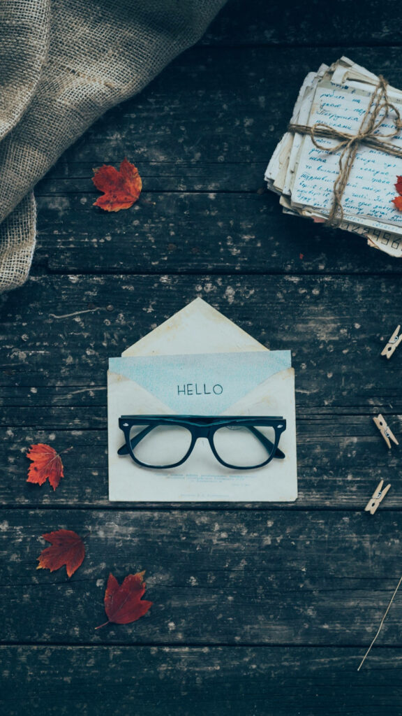 Rustic Wallpaper: Artistic Eyeglasses & Vintage Setup with Hello Note