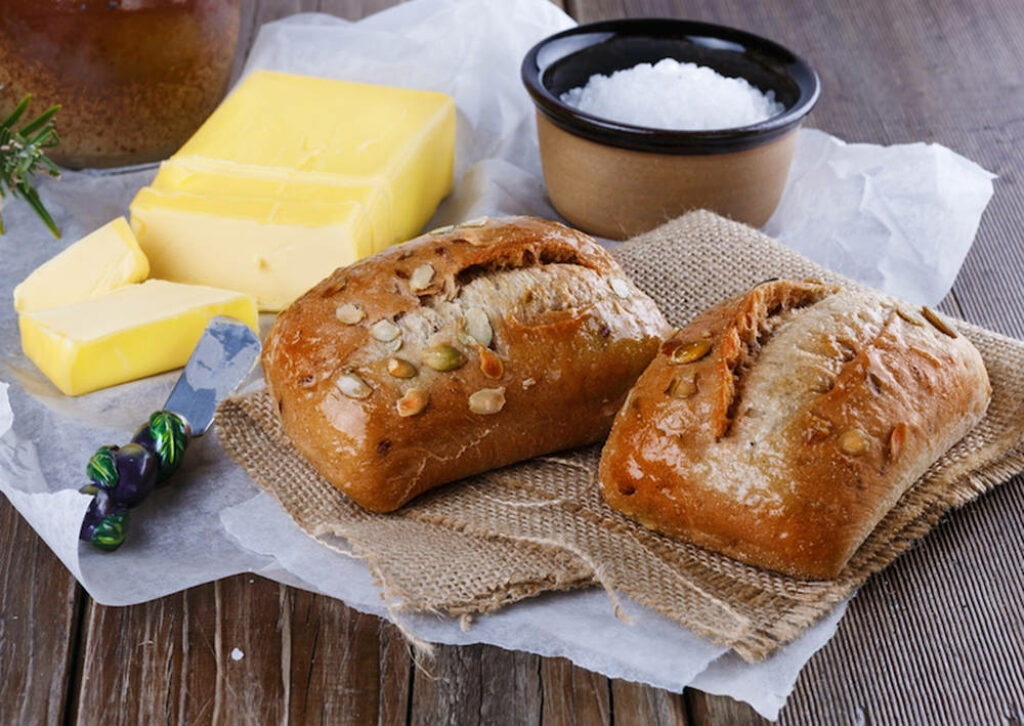 Cozy Rustic Wallpaper: Freshly Baked Bread & Butter on Wooden Table