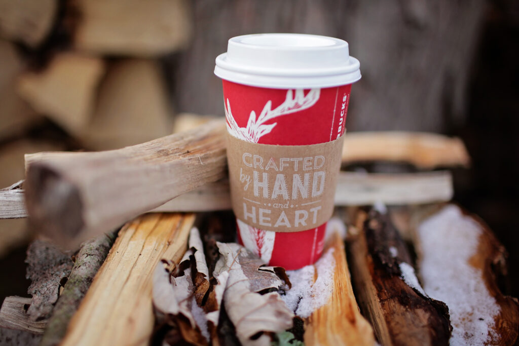 Cozy Rustic Wallpaper: Red Cup 'Crafted by Hand and Heart' on Logs