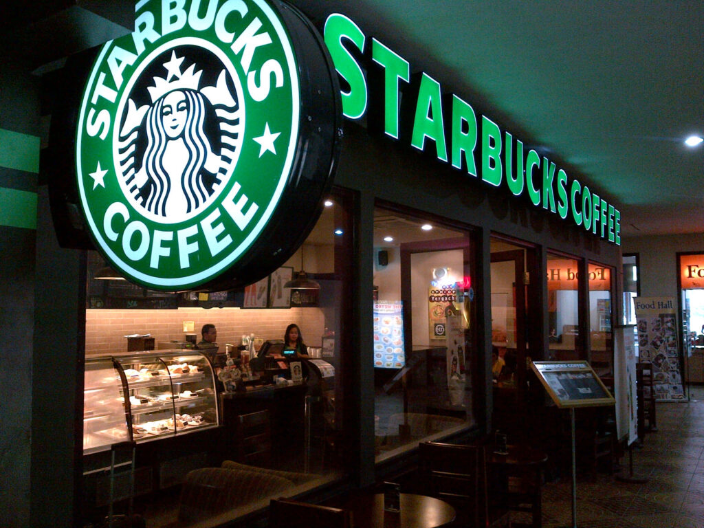 Starbucks café interior cozy ambiance warm lighting green logo relaxing coffee break wallpaper
