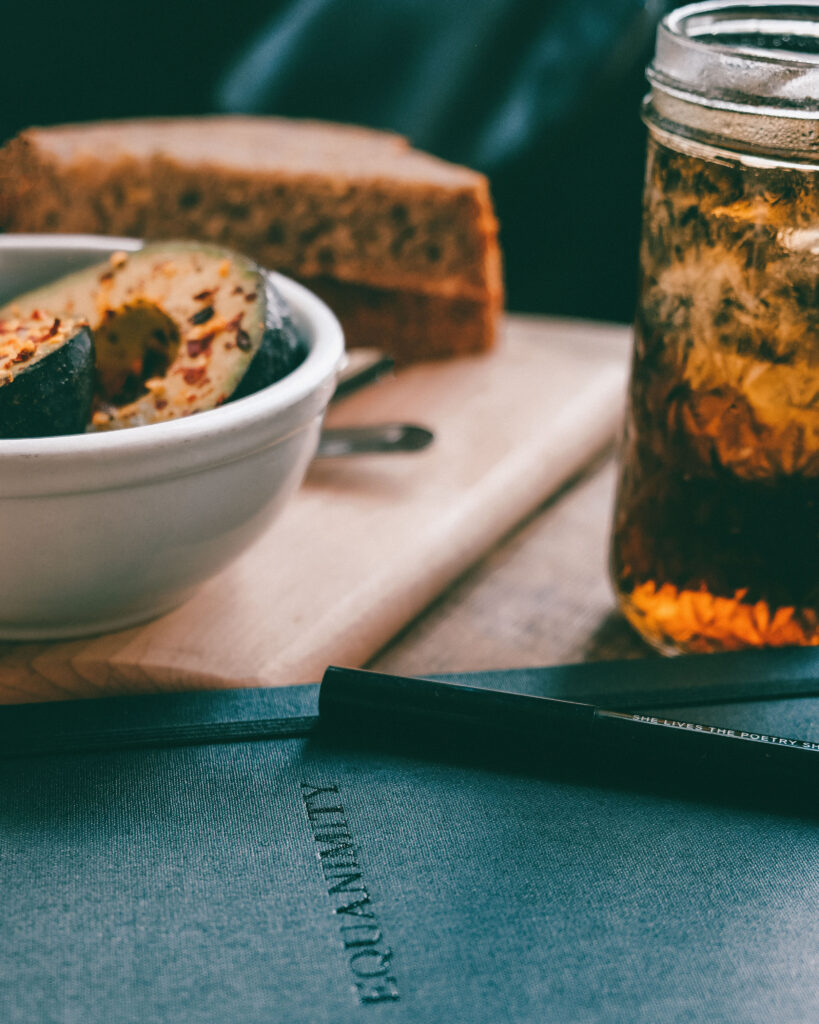 Cozy Still Life: Avocados, Bread & Notebook for Warm Wallpaper