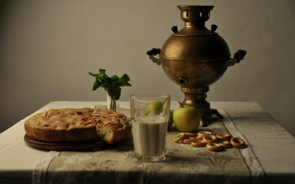 Cozy Still Life: Samovar, Pie & Apples on Rustic Table Wallpaper