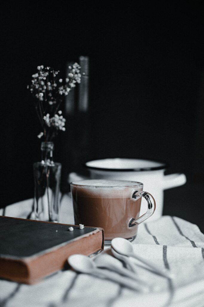 Cozy Still Life: Steaming Coffee and Flowers Wallpaper Background