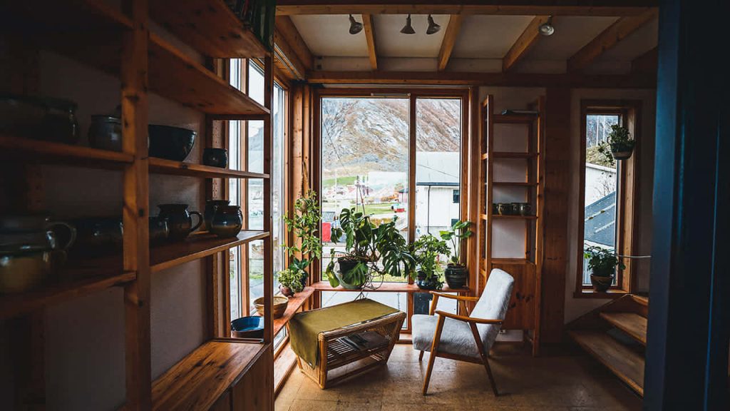 Cozy rustic wooden Zoom background with plants armchair and mountain views in Scandinavian style Wallpaper