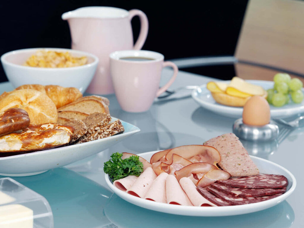 Cozy Table Setup with Fresh Foods & Pastel Tableware Wallpaper