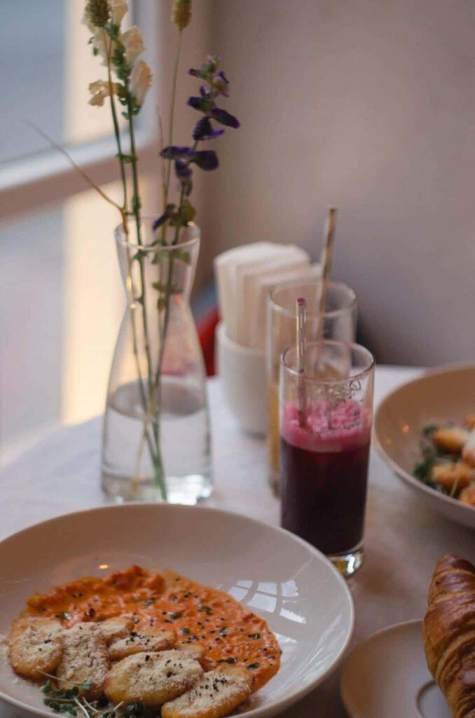 Cozy Table Setup: Delicious Pasta, Bread & Flowers - Wallpaper Background