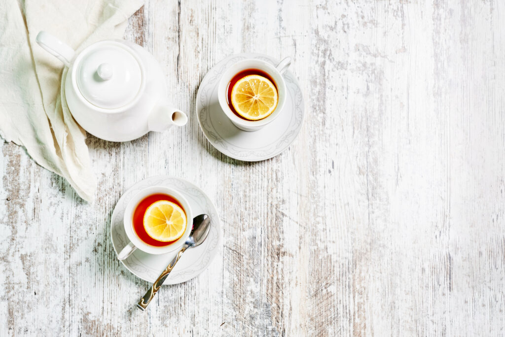 Cozy Tea Setting Wallpaper: Lemon Garnished Tea on Rustic Wood