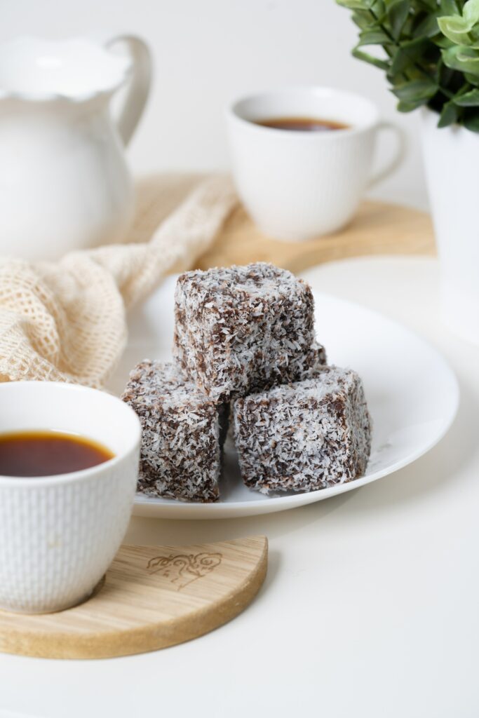 Cozy Tea-Time Setup: Chocolate Coconut Desserts & Steaming Tea Wallpaper