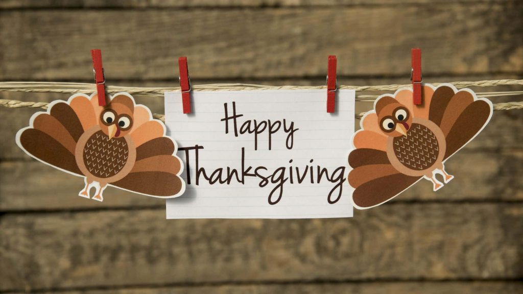 Cute Thanksgiving wallpaper with handwritten note and cartoon turkeys on rustic wood background