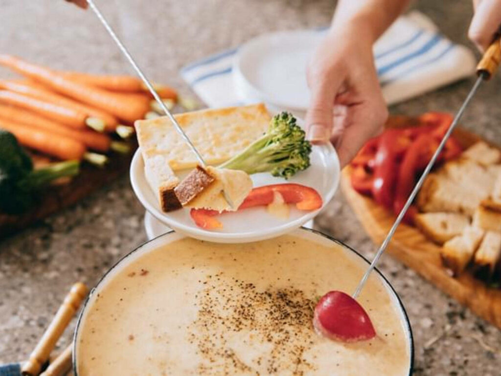 Cozy Cheese Fondue Wallpaper with Fresh Veggies and Bread Setup