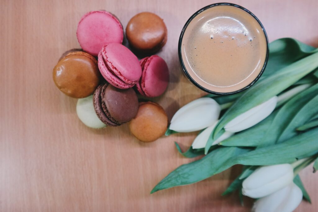 Cozy Macarons & Coffee: Warm Floral Wallpaper Background Design