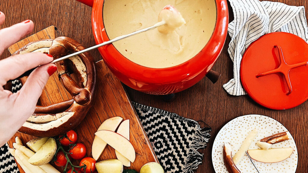 Cozy Cheese Fondue Wallpaper: Warm Dining Scene with Apples & Veggies
