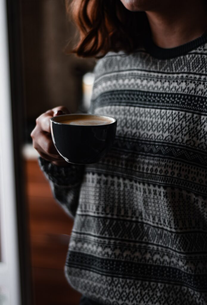 Cozy Wallpaper: Girl with Coffee in Patterned Sweater for Relaxed Vibe