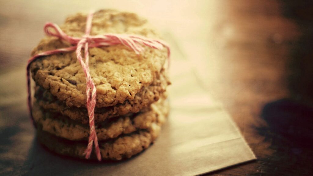 Cozy Wallpaper: Oat Cookies Tied with Pink Thread on Parchment
