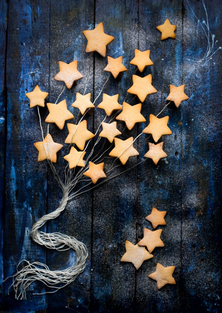 Cozy Star-Shaped Cookie Wallpaper on Rustic Blue Wood Background