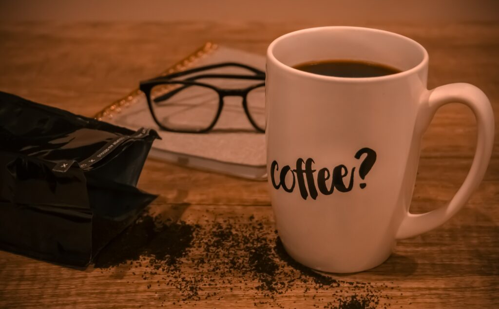 Cozy Wallpaper: White Coffee Cup on Rustic Wood with Coffee Accents