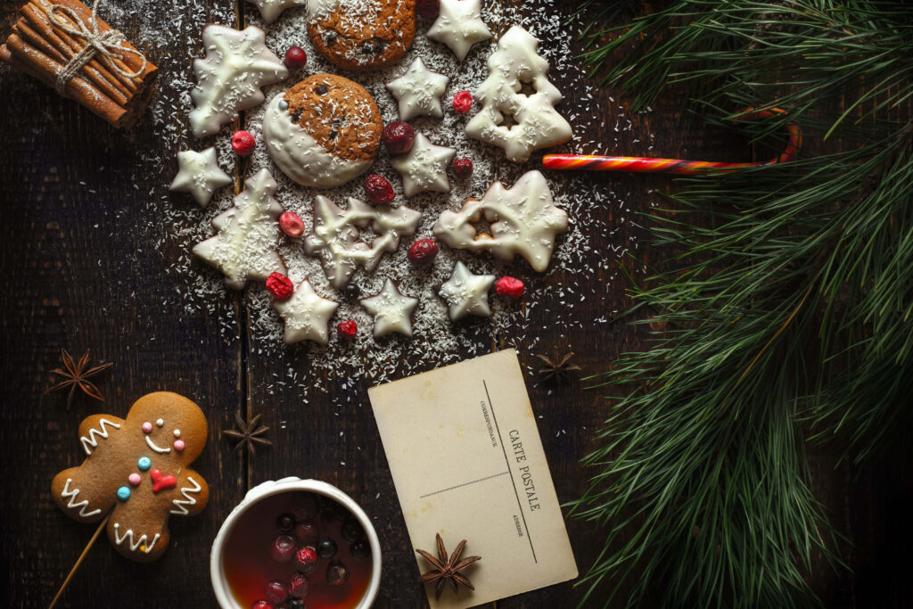 Cozy Winter Scene: Festive Cookies, Gingerbread, and Warm Drink Wallpaper