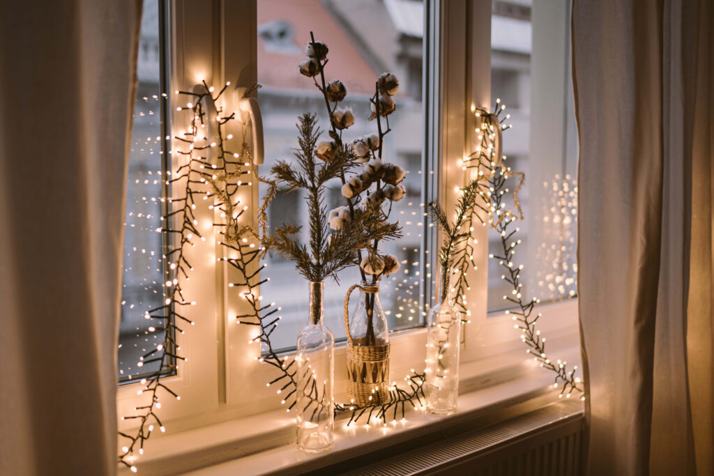 Cozy Wallpaper: Festive Window with String Lights & Snowy View