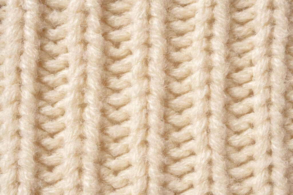 Cozy Wool Texture: Intricate Knitting Patterns for Wallpaper Background
