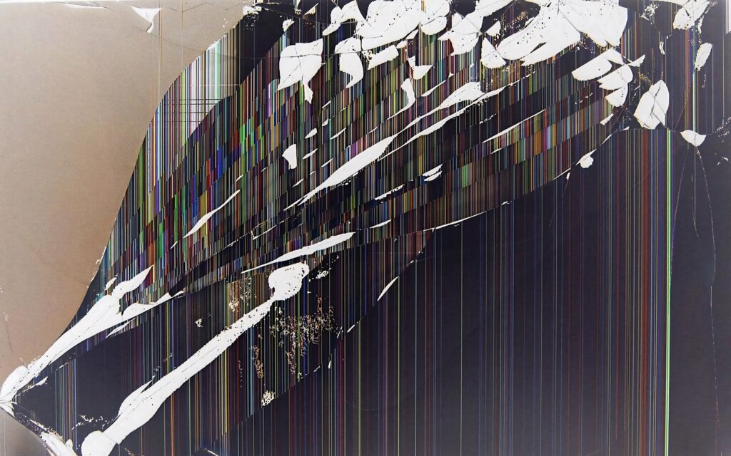 Cracked computer screen with vibrant multicolored vertical lines and shattered glass on black background Wallpaper