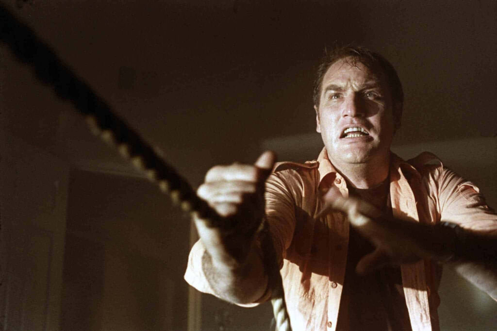 Craig T Nelson pulling a rope with intense determination in a dramatic cinematic scene wallpaper