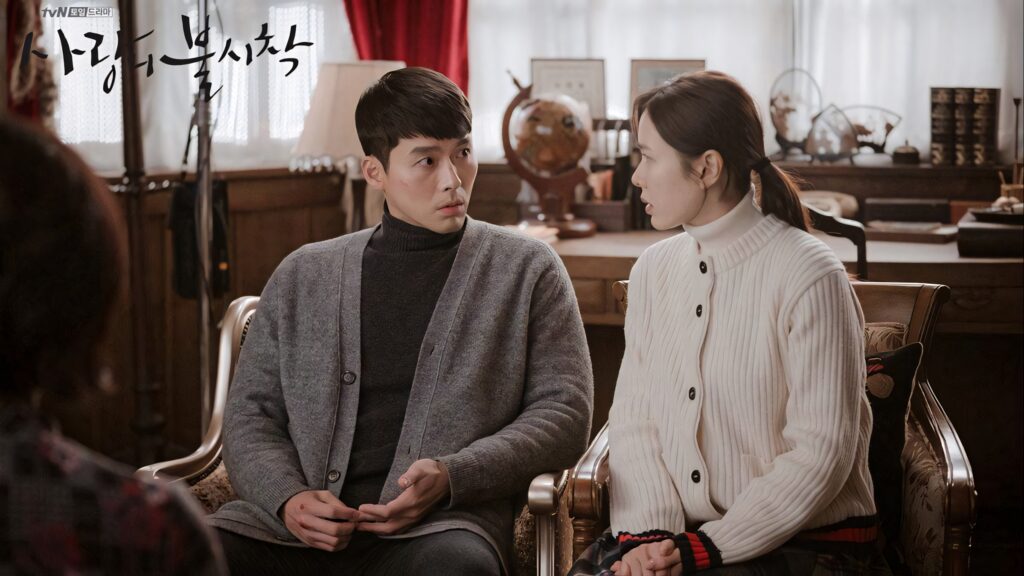 Yoon Se-ri and Ri Jeong-hyeok intense conversation cozy elegant room warm tones Crash Landing On You Wallpaper