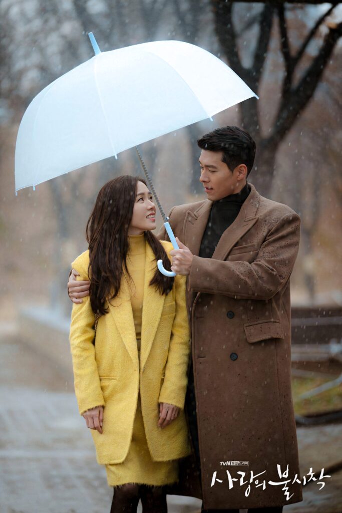 Yoon Se-ri and Ri Jeong-hyeok share a romantic moment under blue umbrella in rainy autumn scene Wallpaper