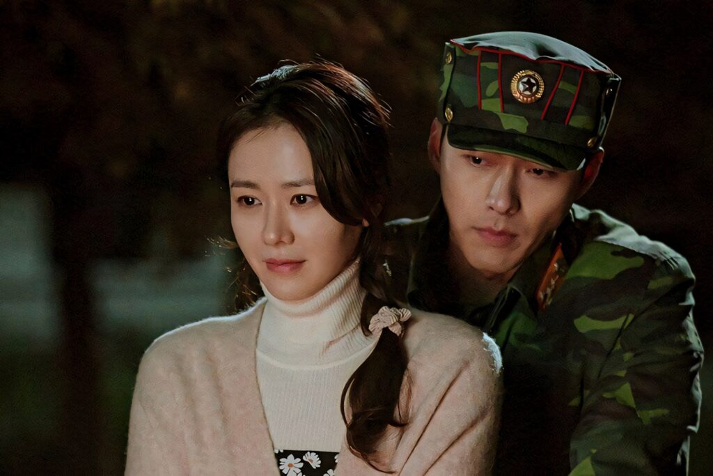 Yoon Se-ri and Ri Jeong-hyeok bike ride romantic moment warm lighting Crash Landing On You wallpaper
